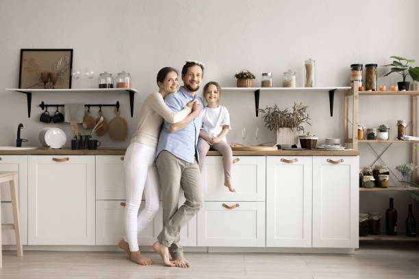 istock Happy family with kid posing in modern renovated kitchen 2161230498