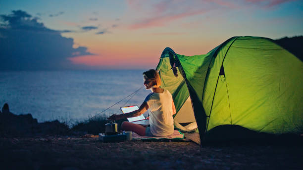 istock Caucasian Female Boosts Productivity with Seaside Camping Office 2161231460