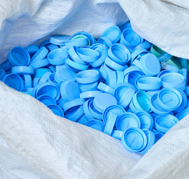 Close-up of blue bottle caps in a plastic bag for recycling