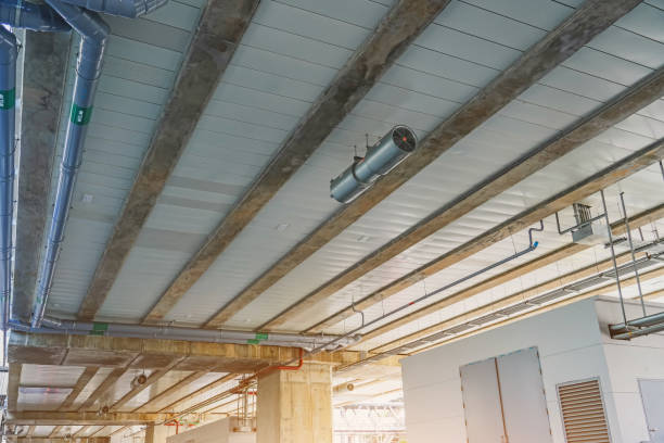 istock Ceiling with water supply and drainage communication pipes under the bridge support station platform. 2161232525