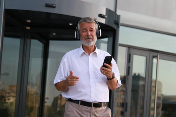 istock Senior businessman dancing and singing after work 2161235714