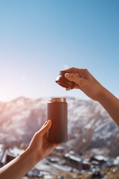 person hand hold reusable thermo cup for hot coffee or tea drink