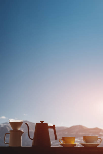 delicious filtered black coffee on mountain background, two mug
