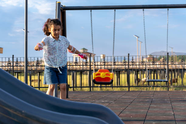 istock Little girl rollerskating in park. 2161238103