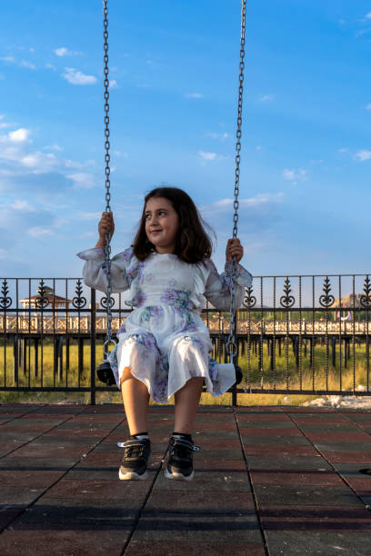 istock The girl on a swing. 2161238856