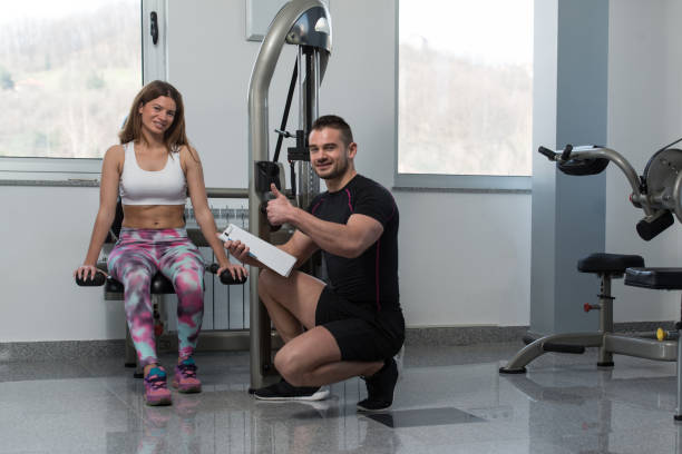 istock Personal Trainer Showing Ok Sign To Client 2161242192