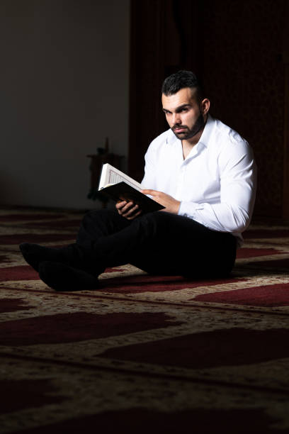 istock Muslim Man Reading Holy Islamic Book Koran 2161243093