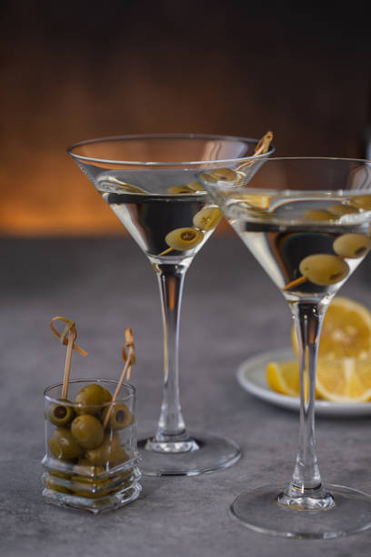 istock Two glasses of martini with olives 2161244676