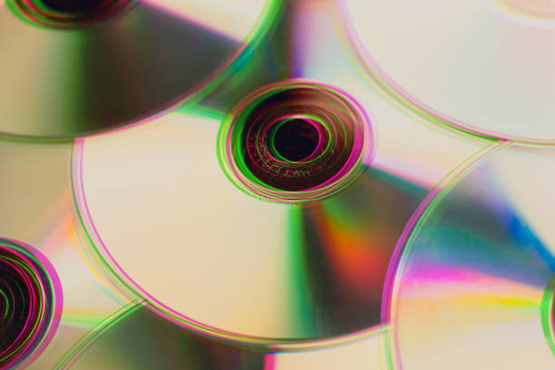 Close up of cd's and dvd's overlapping with color rainbow effect, creating a vintage look