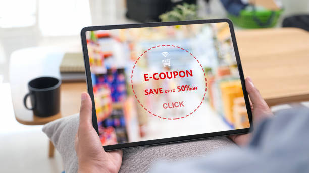 istock Woman hand using laptop computer with grocery E-coupon, discount coupon on screen, online shopping sale, digital marketing, business and technology concept 2161252924