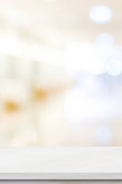 istock Empty white table top, counter, desk background over blur perspective bokeh light background, White marble stone table, shelf and blurred kitchen restaurant for food, product display mockup, template 2161252959