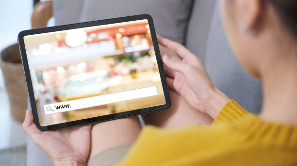 istock Hand holding digital tablet with www. on search bar over blur store background on screen, on line shopping ,business, E-commerce, technology and digital marketing concept background 2161252987