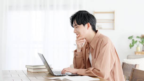 A man thinking at a computer stock photo