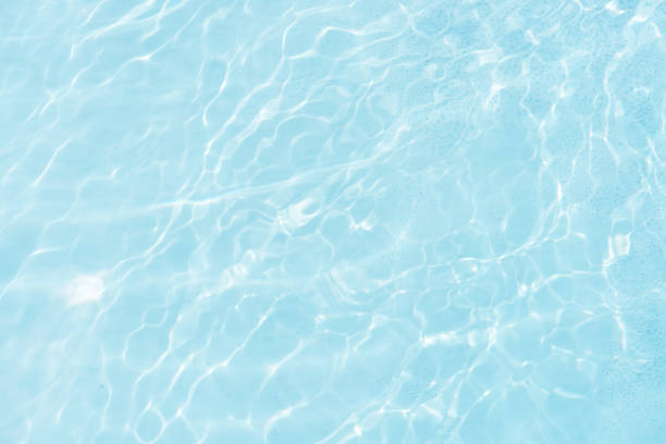 istock Blue water with ripples on the surface. Defocus blurred transparent blue colored clear calm water surface texture with splashes and bubbles. Water waves with shining pattern texture background. 2161257221