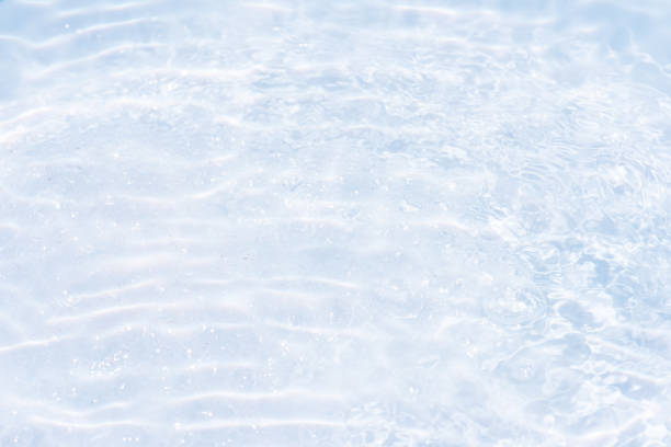 istock Blue water with ripples on the surface. Defocus blurred transparent blue colored clear calm water surface texture with splashes and bubbles. Water waves with shining pattern texture background. 2161257340