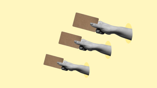 istock Three hands holding cards with a yellow background 2161259323