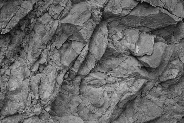 istock Black white light gray rock stone basalt mountain granite volcanic texture background. Close-up. 3d. Cracked, broken. 2161259474