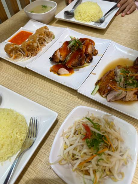 istock Hainanese chicken rice with soup and  sauces on white table 2161261188
