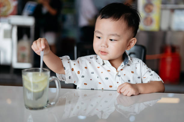 istock Happy Asian boy enjoying lemonade 2161267918