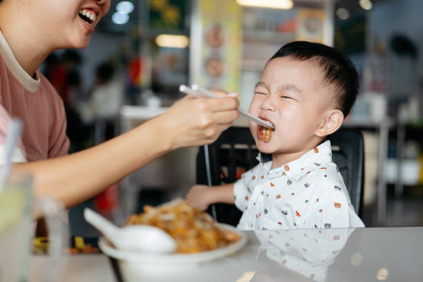 istock Happy Asian mother and son enjoying breakfast 2161267934