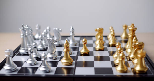 istock Silver and gold chess pieces are on the chessboard. 2161270499
