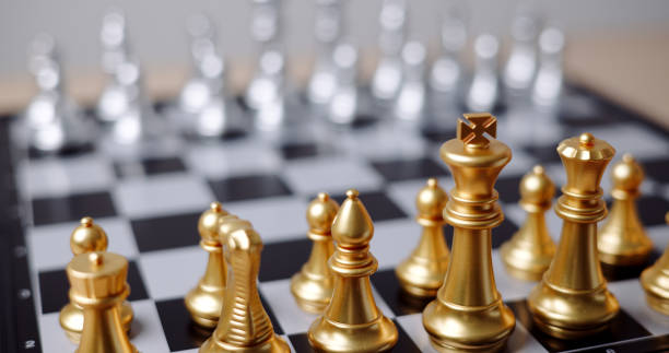 istock Focus on golden chess pieces on chessboard. 2161270530