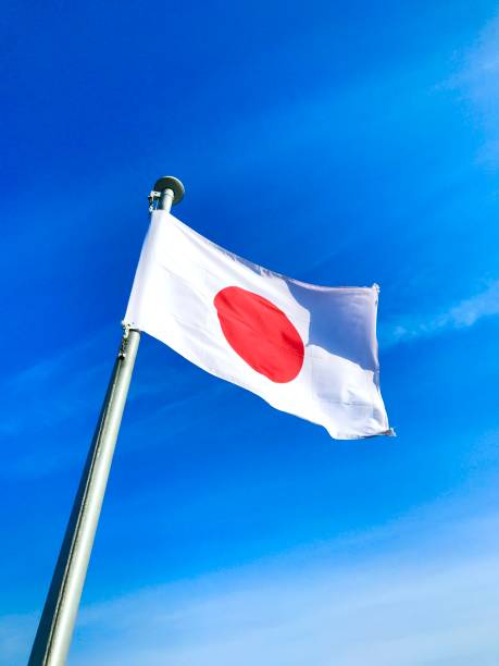 istock Japan flag on flagpole with blue sky background, vertical 3:4 ratio with copy space 2161271692