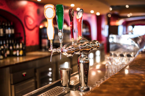 istock Shiny beer taps on  bar against blurred background 2161274241