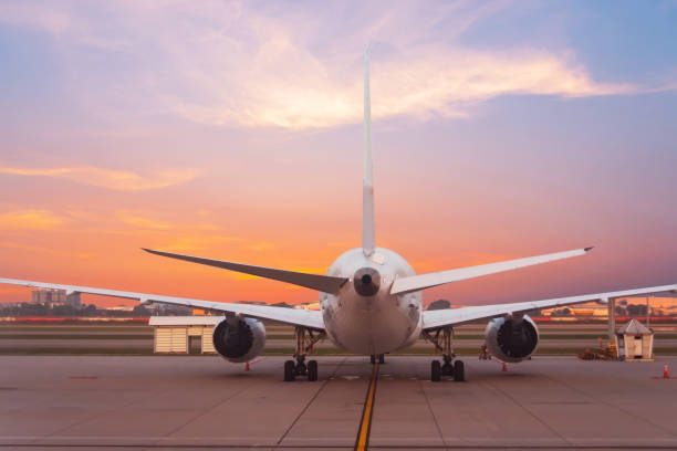 istock Passenger plane parked in the air harbor during dawn sky, rear view 2161279442