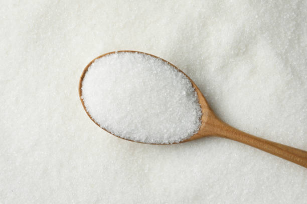 istock Wooden spoon on granulated sugar, top view 2161280266