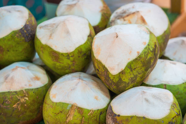 Coconuts are ready to sell at the market stall.