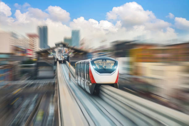 istock High speed monorail train with bright headlights passes race station on the stage through a tunnel at a road junction around metropolis cityscape urban scape 2161282840