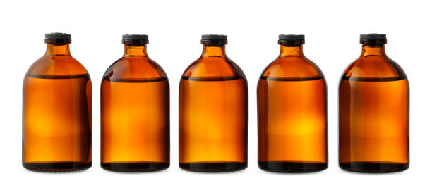 istock Five Amber Glass Bottles With Liquid on White Background 2161283295