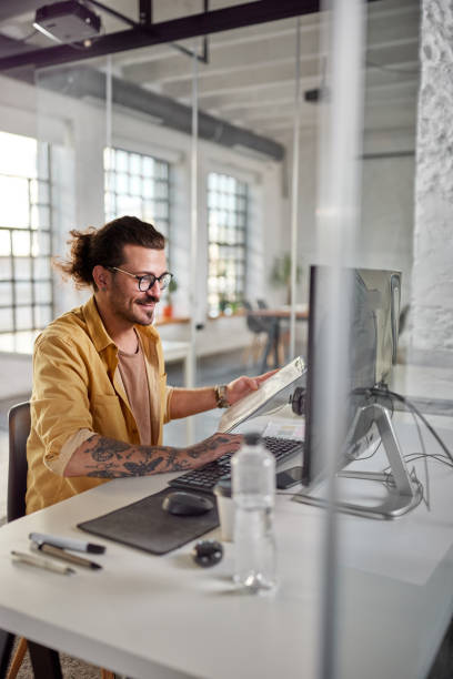 istock Happy businessman working on reports and PC at corporate office. 2161283819