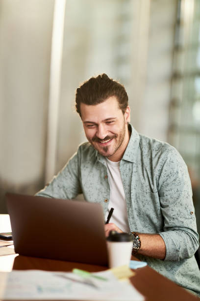 istock Happy male freelancer working on laptop in the office. 2161284123