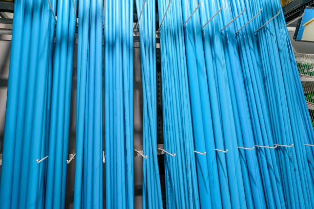 Various blue plastic pipes on the counter in a store.