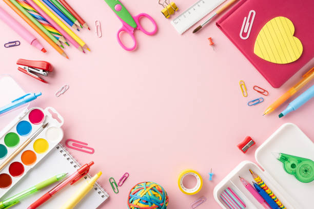 istock Bright and colorful school stationery arranged on a pink background, featuring pencils, markers, notebooks, and art supplies 2161286607