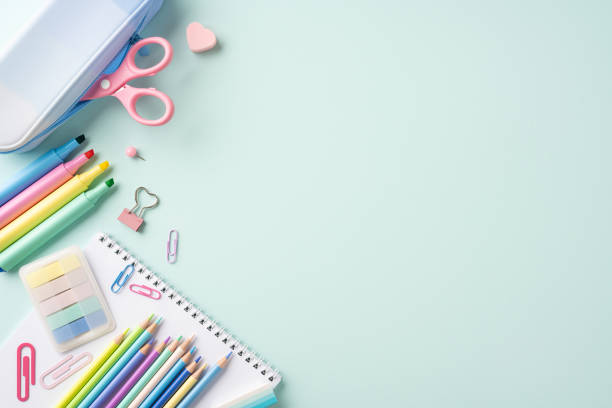 istock Colorful school stationery items on a light pastel background, including pencils, scissors, and paper clips 2161286614