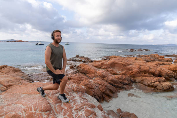 istock Oceanfront Fitness: Man Exercising on Rocky Coast 2161289387
