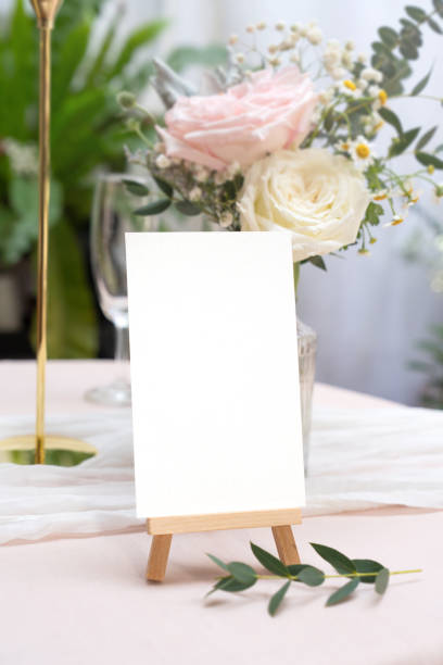 istock Mockup white blank space card, for greeting, table number, wedding invitation template on wedding table setting background. 2161290876