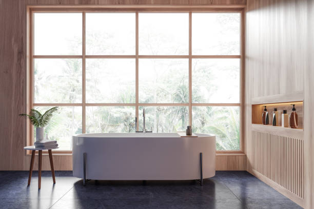 istock Luxury hotel bathroom interior with white tub, shelf and panoramic window 2161293445