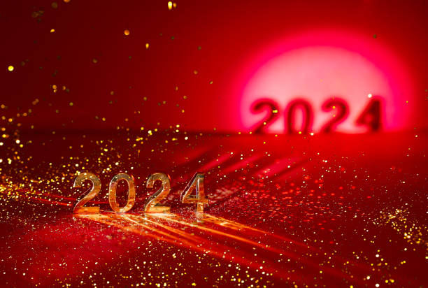 istock 2024 gold colored numbers and glittering confetti on a vivid bright red background 2161299897