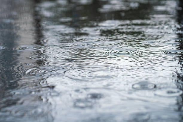 istock Rain in the city. Circles on the puddle surface. 2161300154