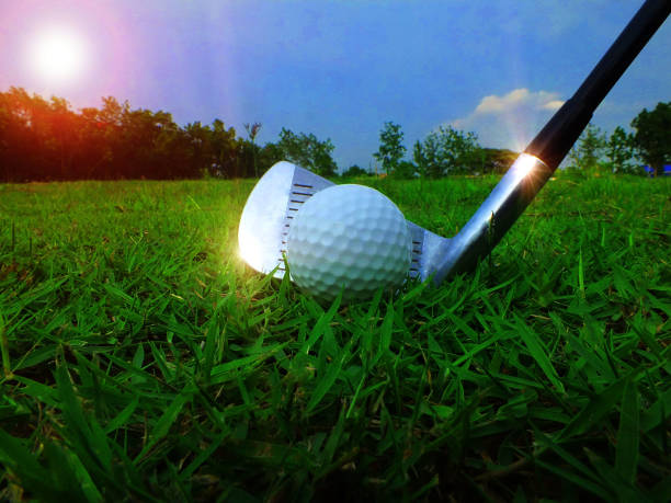 istock White golf ball and athlete's hitting iron 2161300410