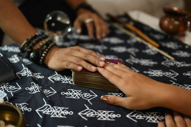istock Fortune teller and client hand touching deck of cards tarot cards. Forecasting and divination concept 2161302499