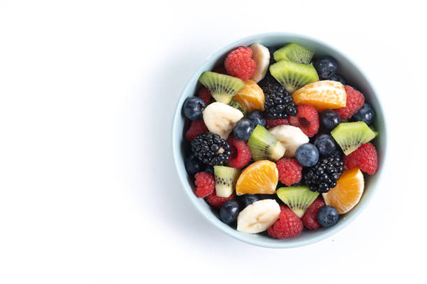 istock Fruit salad in a blue bowl isolated on white background 2161302841