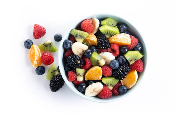 istock Fruit salad in a blue bowl isolated on white background 2161302856