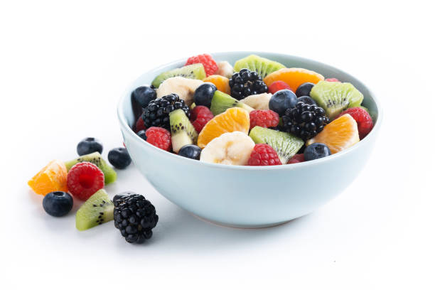 istock Fruit salad in a blue bowl isolated on white background 2161302870