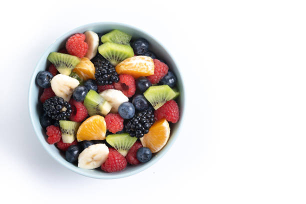 istock Fruit salad in a blue bowl isolated on white background 2161302914