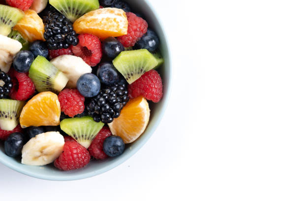 istock Fruit salad in a blue bowl isolated on white background 2161302932